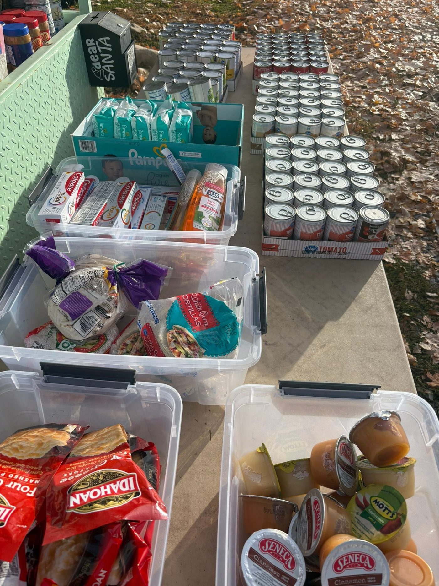 Shelves stocked with canned goods and staples inside the West Side Blooms community food pantry booth in Heber City